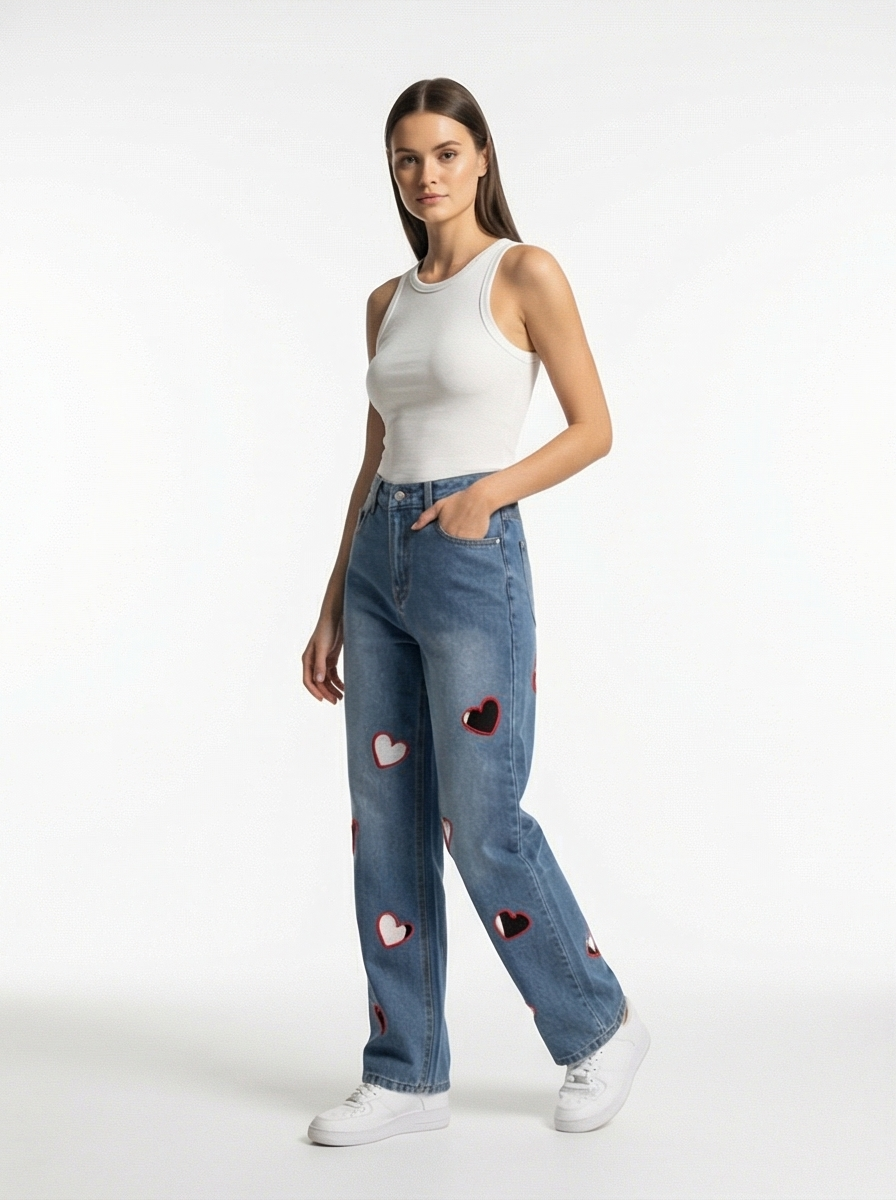 Woman wearing blue jeans with heart patches on a white background