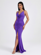 Woman wearing a purple dress with a floral detail on a white background