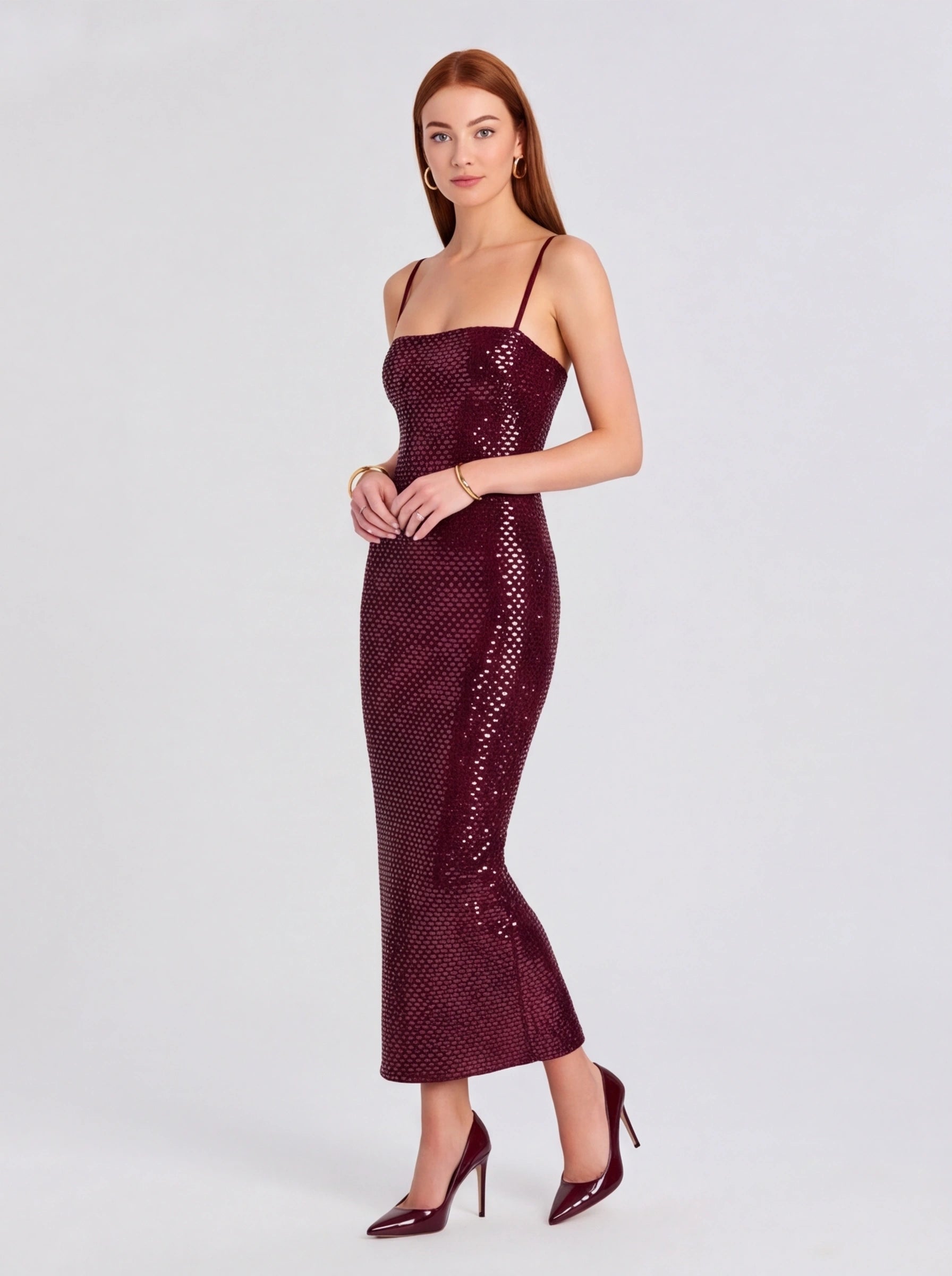 Woman wearing a burgundy sequin dress on a white background