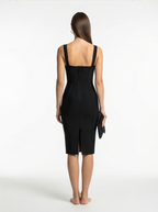 Woman wearing a black dress with a white background