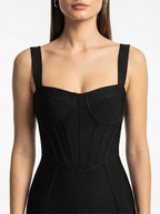 Black dress with a fitted bodice on a white background