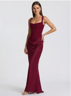 Woman wearing a burgundy evening gown on a white background