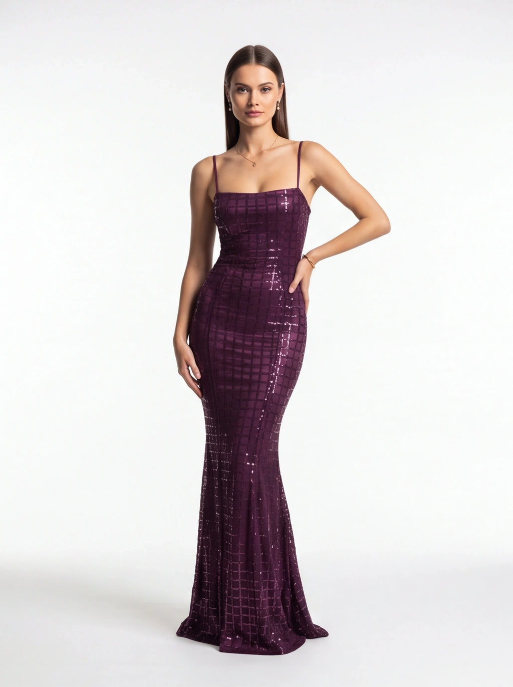 Woman wearing a purple sequin dress on a white background