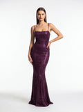 Woman wearing a purple sequin dress on a white background