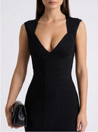 Black dress worn by a model on a white background
