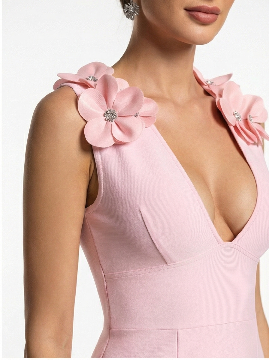 Pink dress with floral shoulder details on a white background