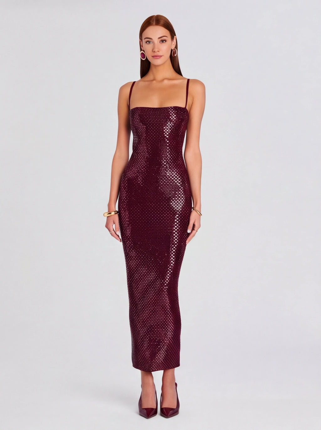 Woman wearing a burgundy sequin dress on a light gray background