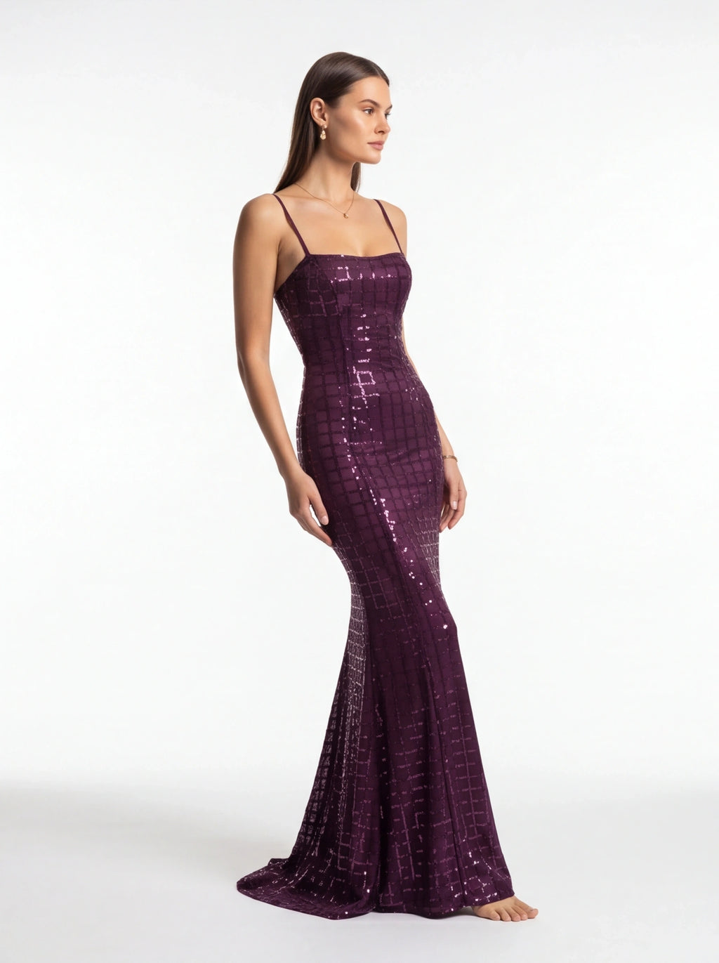 Woman wearing a purple sequin dress on a white background