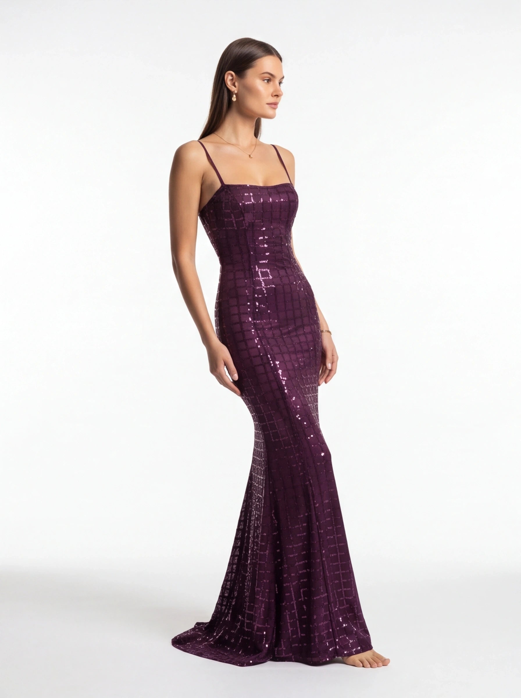 Woman wearing a purple sequin dress on a white background