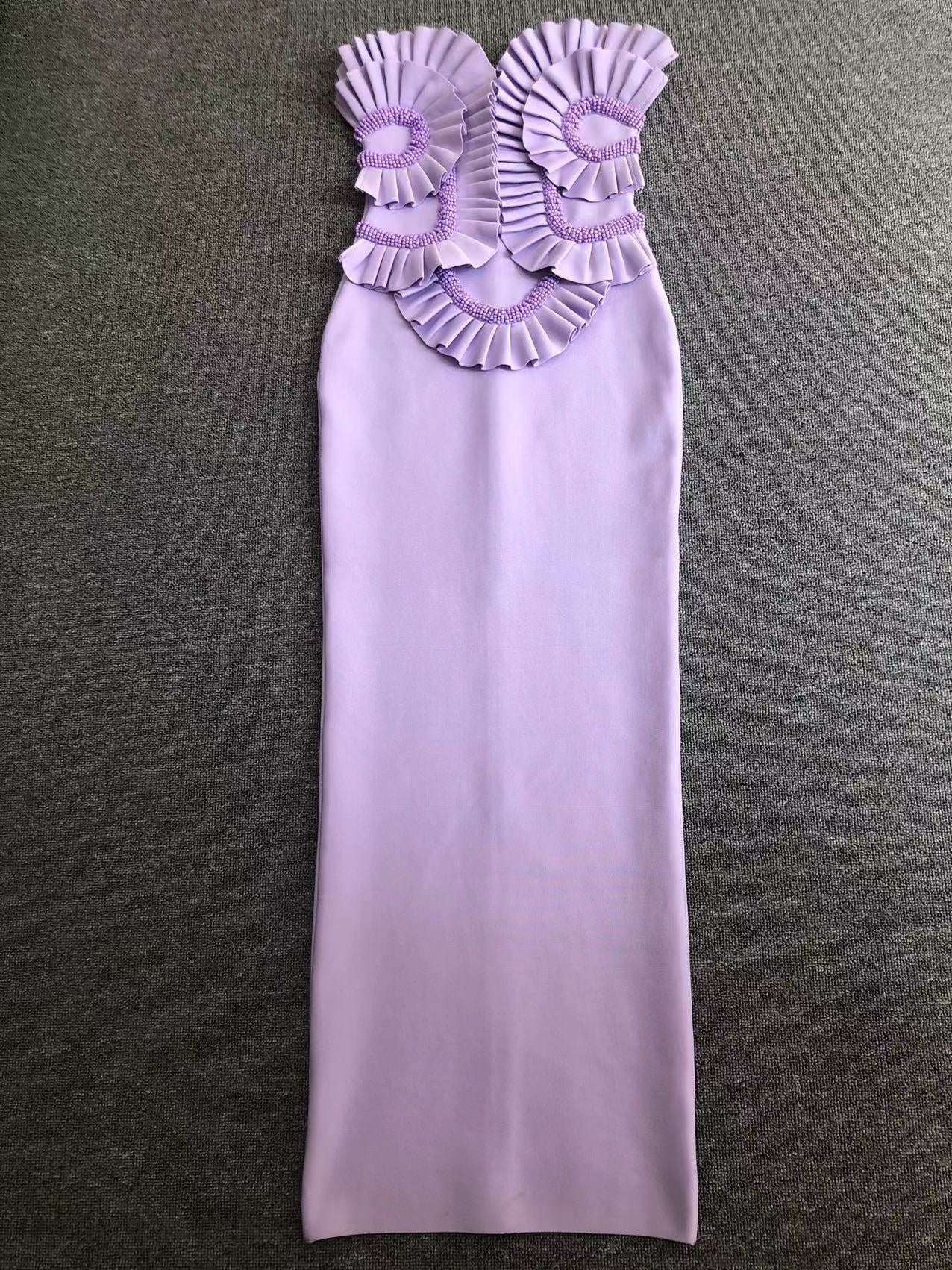 Lavender strapless dress with floral embellishments on a gray background