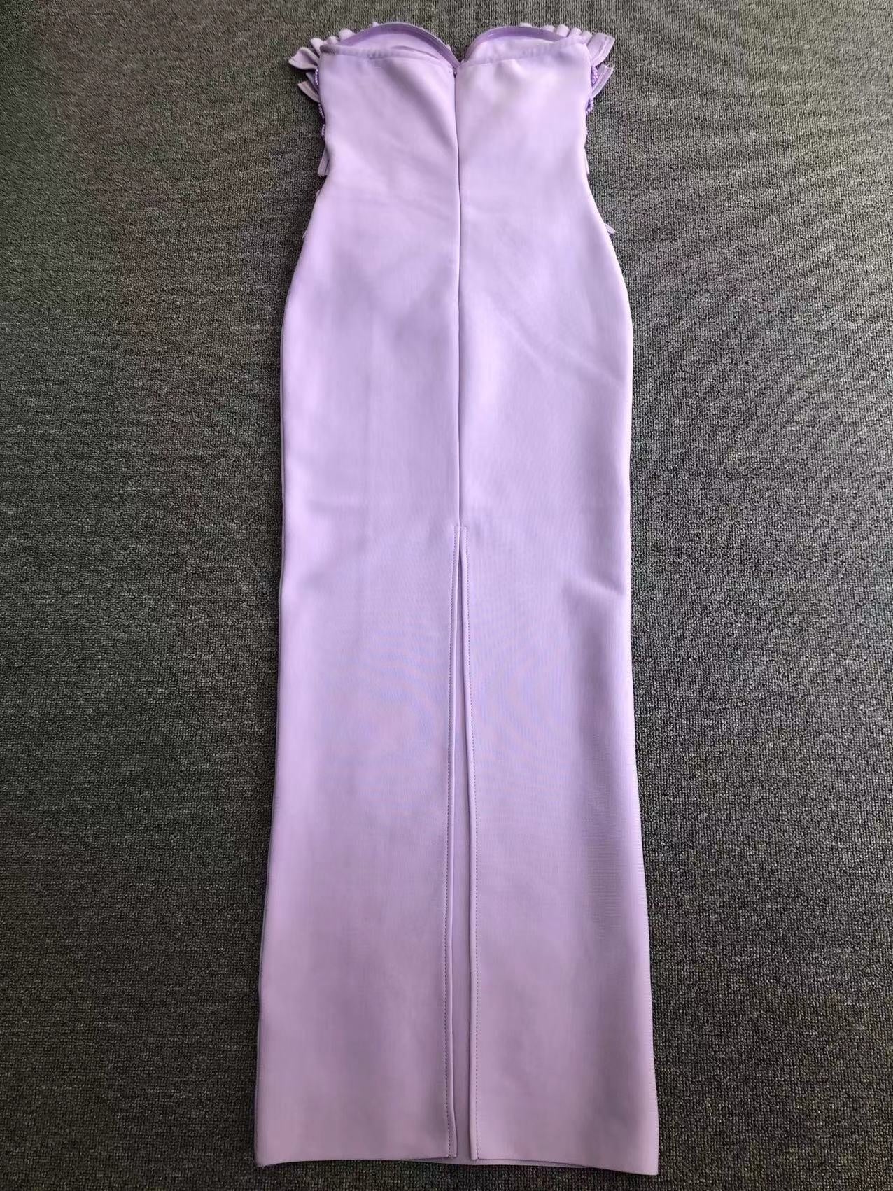 Purple strapless dress on a gray surface