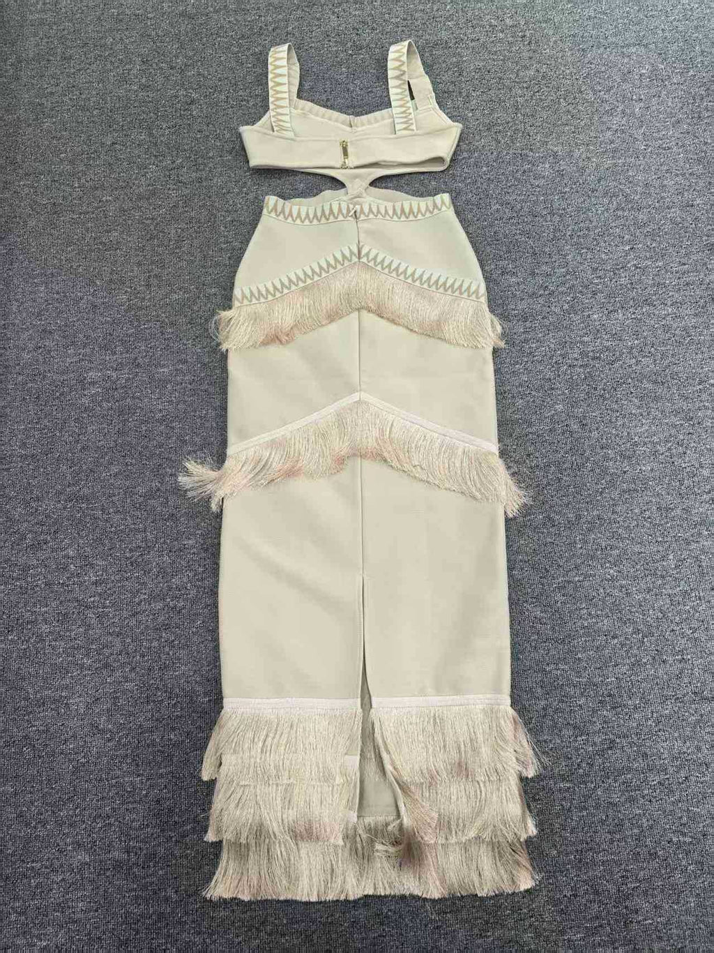 Beige fringe dress and top set on a gray background