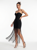 Black strapless dress with fringe details on a white background