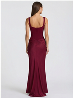 Woman wearing a burgundy evening gown on a white background