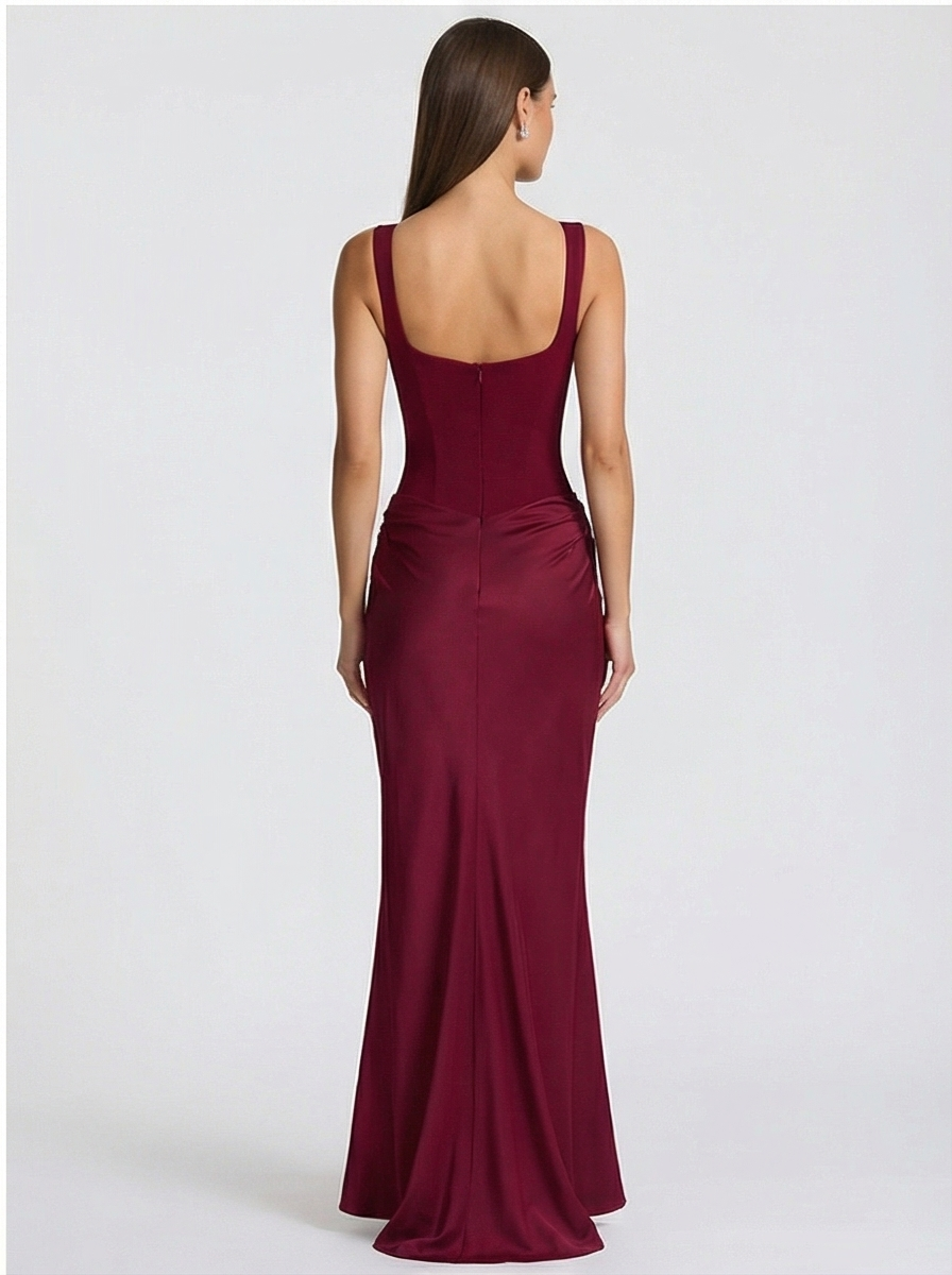 Woman wearing a burgundy evening gown on a white background