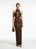 Woman wearing a brown floral dress on a white background