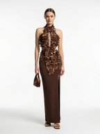 Woman wearing a brown floral dress on a white background