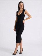 Woman wearing a black dress with a plunging neckline on a white background