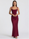Woman wearing a burgundy evening gown on a white background