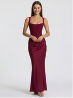 Woman wearing a burgundy evening gown on a white background