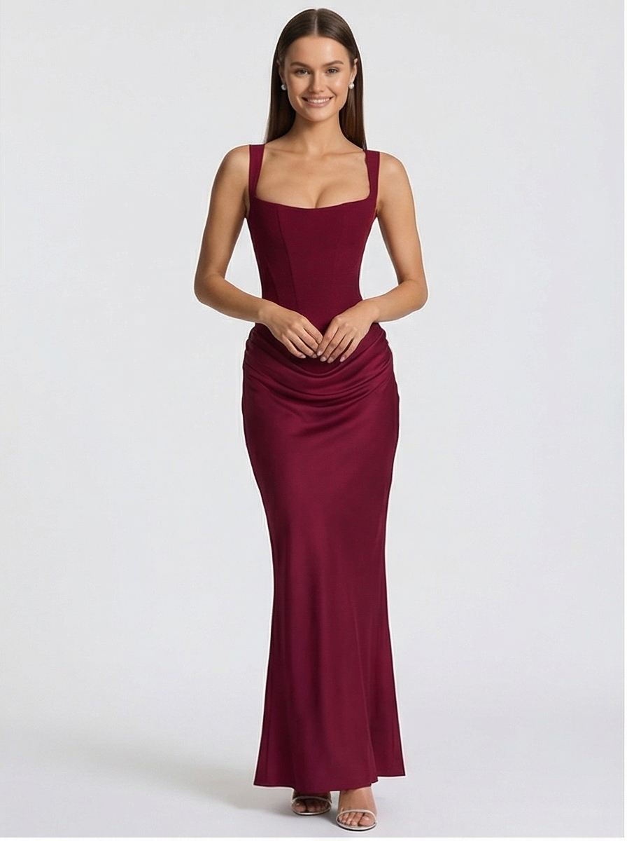 Woman wearing a burgundy evening gown on a white background