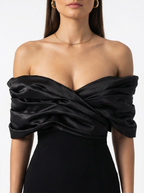 Black off-shoulder dress worn by a model on a white background