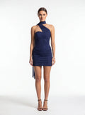 Woman wearing a blue halter neck dress on a white background