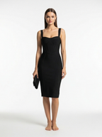 Woman wearing a black dress on a white background