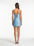 Light blue dress with lace-up back worn by a model on a white background