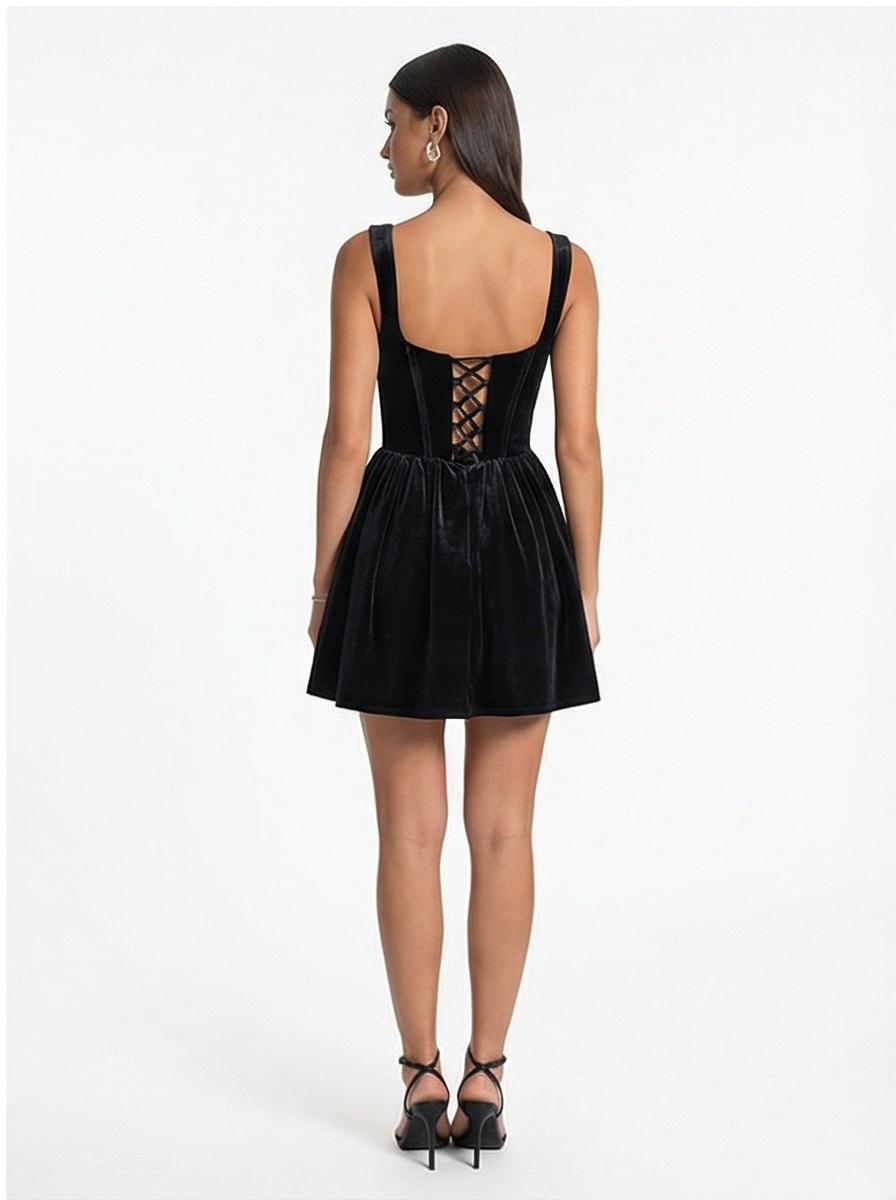 Black dress with lace-up back worn by a model on a white background