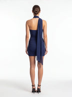 Navy blue halter neck dress with a draped effect on a white background