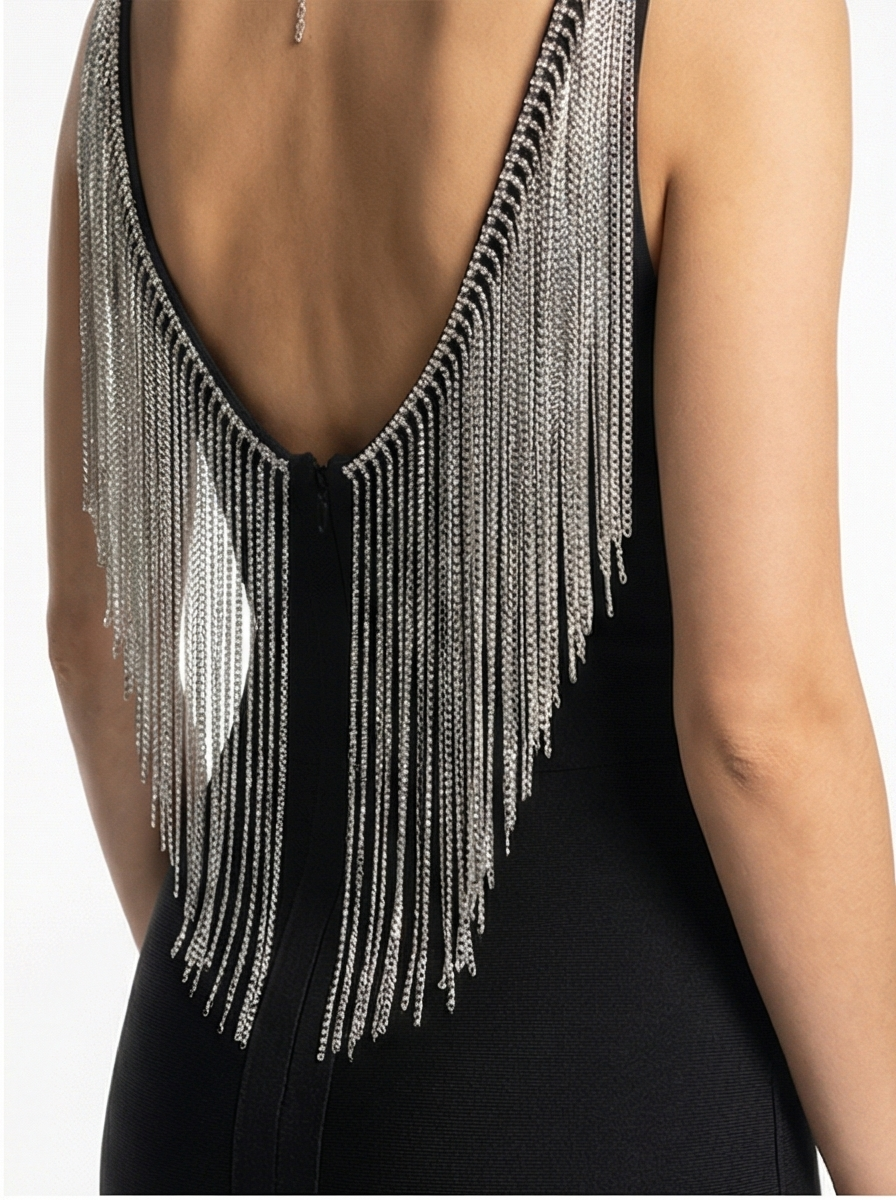 Black dress with silver fringe details on a white background