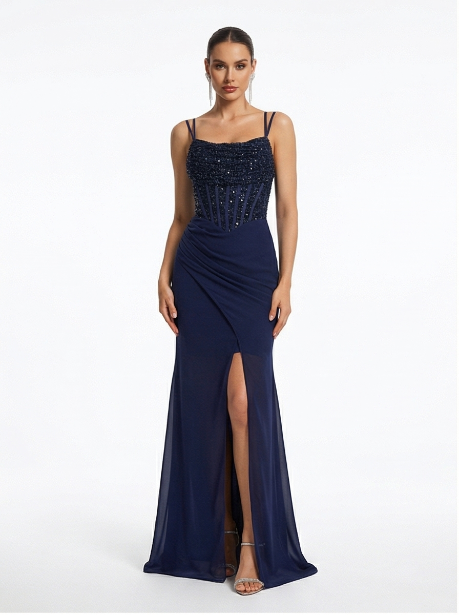 Navy blue evening gown with beaded top and slit skirt on a white background