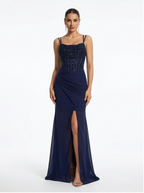 Navy blue evening gown with beaded top and slit skirt on a white background
