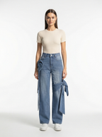 Woman wearing blue jeans with a white background