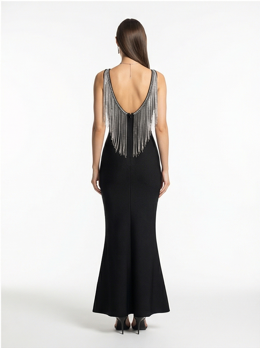 Black evening gown with fringe details on a white background