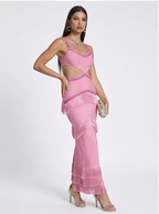 Woman wearing a pink fringe dress on a white background