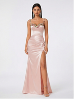Pink evening gown with floral embellishments on a white background