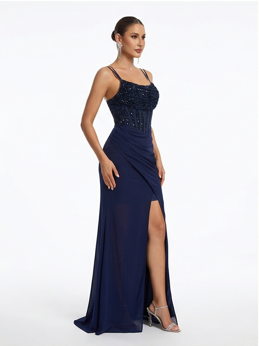 Navy blue evening gown with beaded top and slit skirt on a white background