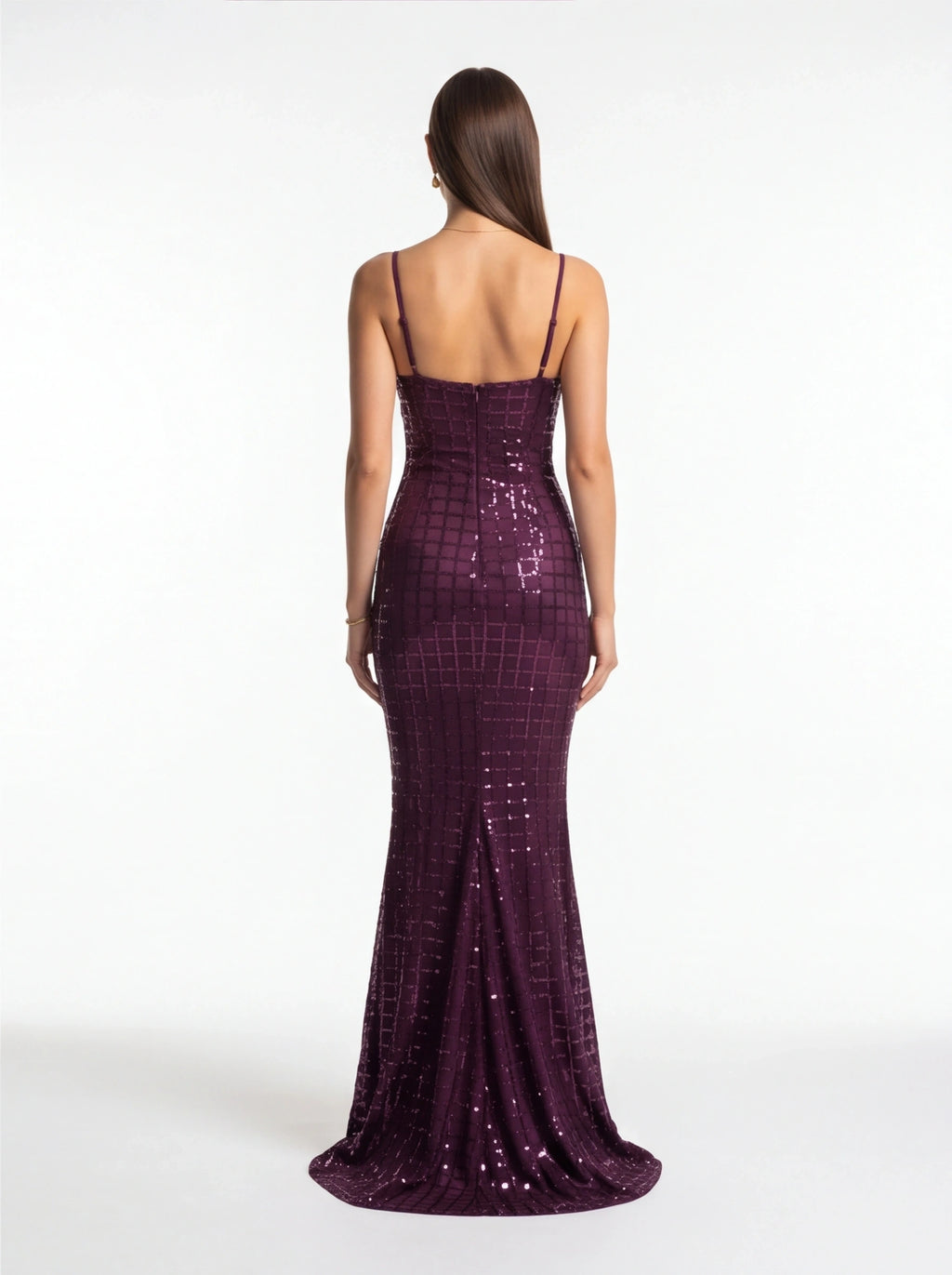 Woman wearing a purple sequin dress on a white background