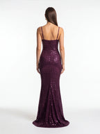 Woman wearing a purple sequin dress on a white background