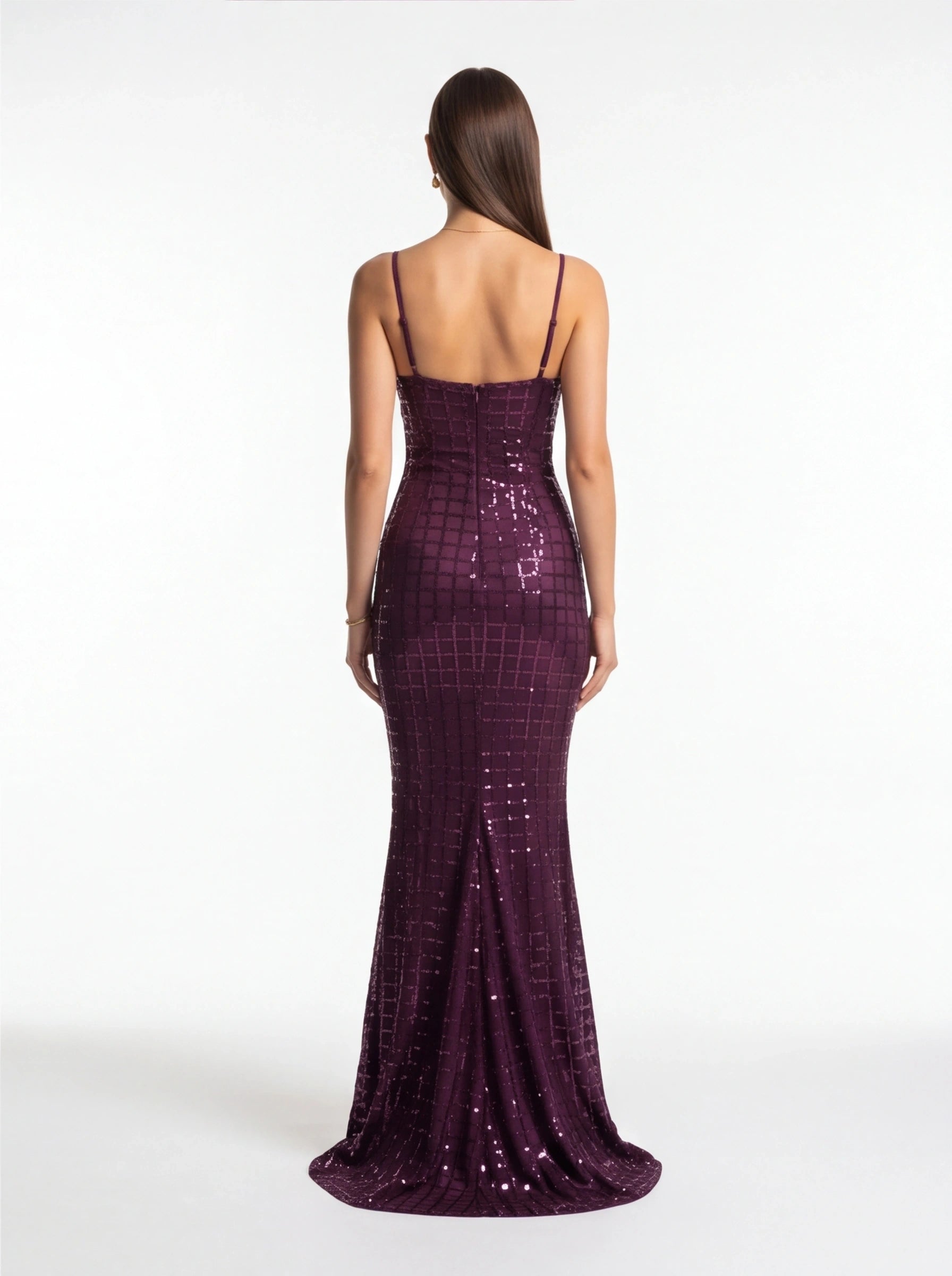 Woman wearing a purple sequin dress on a white background