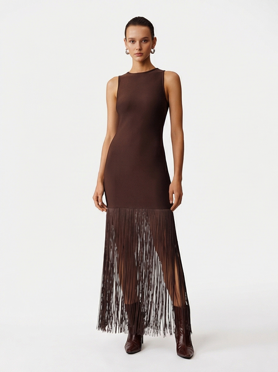 Woman wearing a brown dress with fringe details on a white background