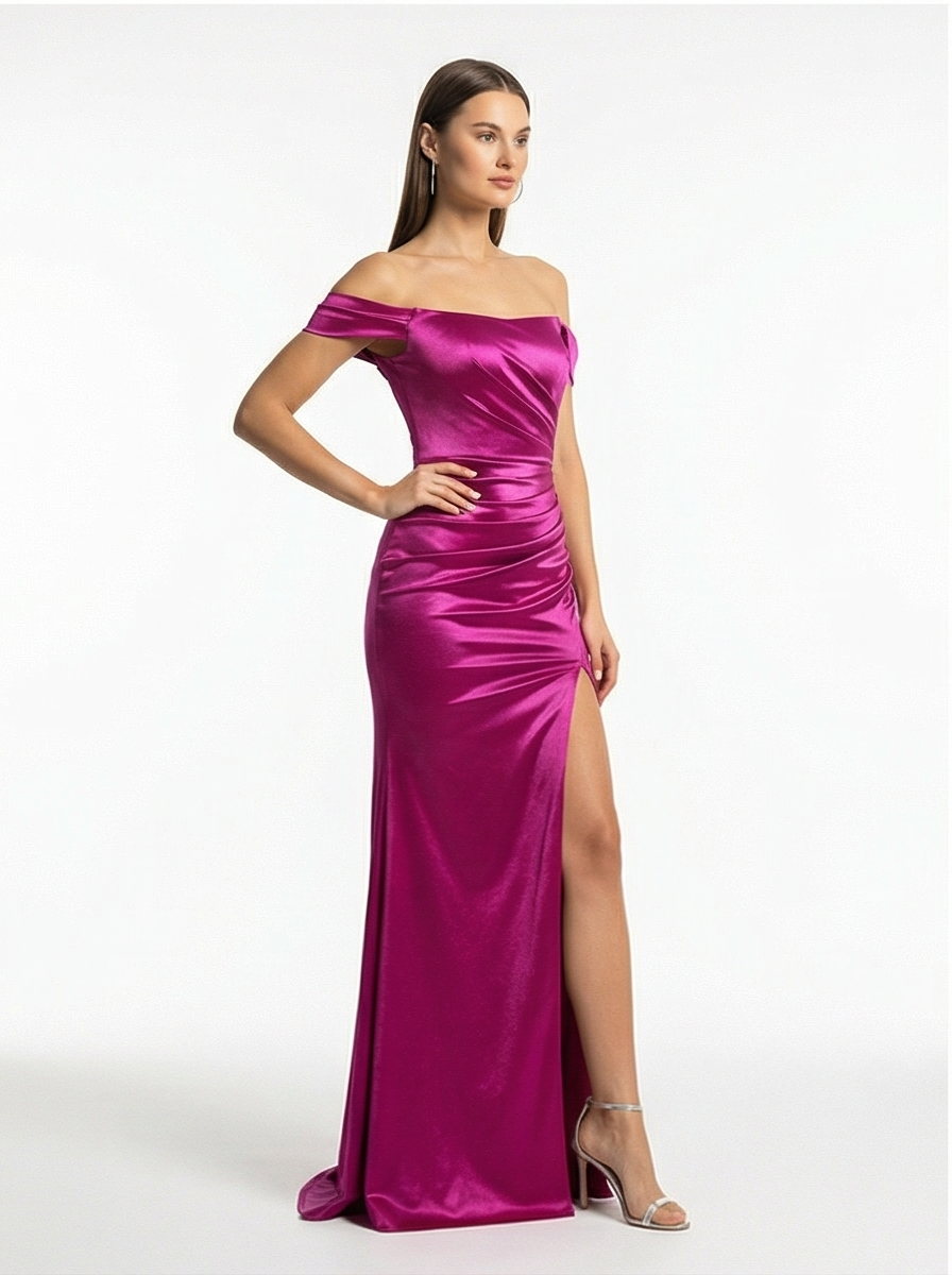 Woman wearing a vibrant pink off-shoulder gown with a slit on a white background