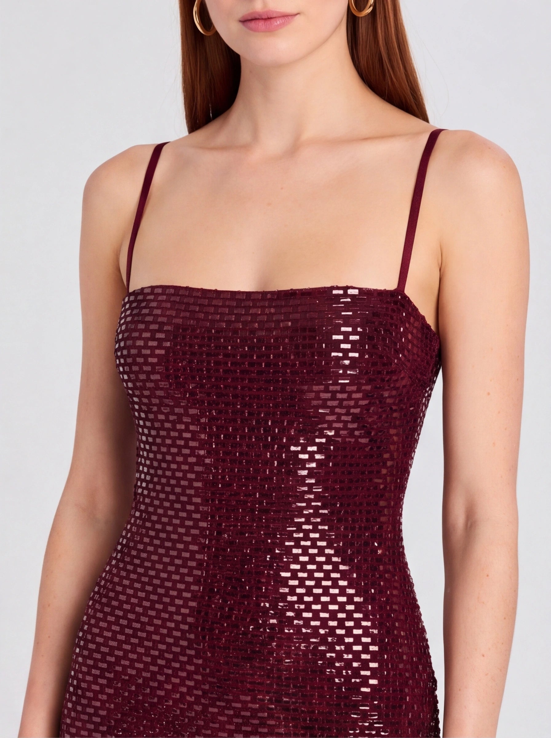 Burgundy sequin dress worn by a model on a plain background