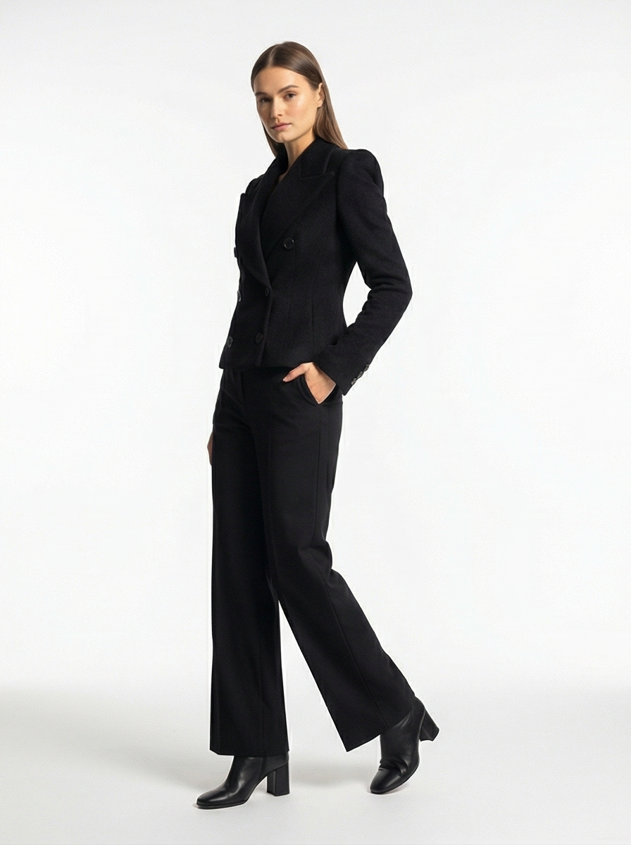 Woman wearing a black suit on a white background