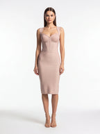 Woman wearing a light pink dress on a white background