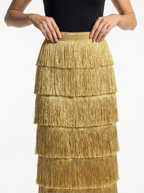 Gold fringe skirt worn by a person on a white background