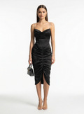 Woman wearing a black dress with a white background