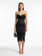 Woman wearing a black dress with a white background